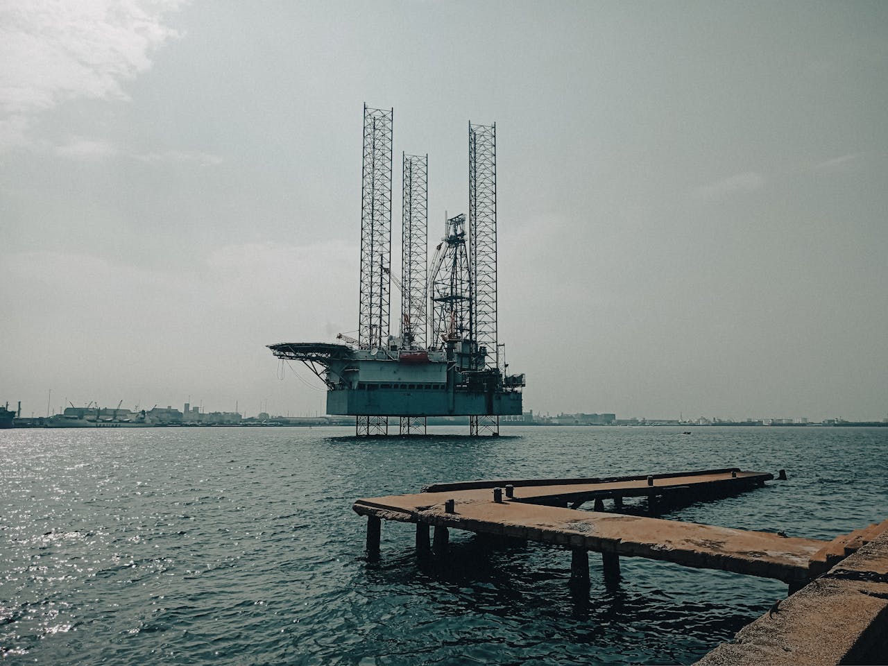 Offshore oil platform in urban harbor, showcasing industrial scenery and oceanic platform structure.
